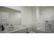 Well-lit bathroom with white fixtures, including a modern vanity and a shower-tub combo at 1217 Trombone Way # 6, Mcdonough, GA 30252