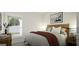 Bedroom featuring a comfortable bed with a window providing natural light and cozy decorative pillows at 1217 Trombone Way # 6, Mcdonough, GA 30252