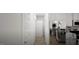 Hallway leading into a bright kitchen with modern stainless steel appliances and white cabinetry at 1217 Trombone Way # 6, Mcdonough, GA 30252