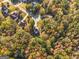An aerial view of a house surrounded by lush autumn foliage in a tranquil neighborhood at 1412 Short Ct, Mcdonough, GA 30252