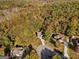 An aerial shot of a home nestled in a vibrant, tree-filled neighborhood with colorful autumn foliage at 1412 Short Ct, Mcdonough, GA 30252