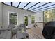 Cozy covered back deck with outdoor seating and a grill, perfect for entertaining at 1412 Short Ct, Mcdonough, GA 30252