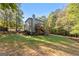 A large, well-maintained backyard features a spacious lawn and mature trees at 1412 Short Ct, Mcdonough, GA 30252