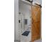 Bathroom showcasing a wooden sliding barn door and a glass enclosed shower at 1412 Short Ct, Mcdonough, GA 30252
