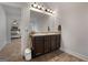 Bathroom featuring a double vanity with granite countertop, tiled floors, and access to the bedroom at 1412 Short Ct, Mcdonough, GA 30252