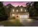 Inviting two-story home with brick accents, manicured lawn, and a spacious two-car garage at 1412 Short Ct, Mcdonough, GA 30252