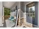 Inviting front porch with seating, rustic welcome sign, and a stylish gray front door at 1412 Short Ct, Mcdonough, GA 30252