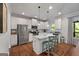 Bright kitchen featuring white cabinets, a center island with seating, and modern appliances at 1412 Short Ct, Mcdonough, GA 30252