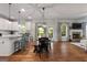 Open-concept living space with hardwood floors, a dining area, and cozy fireplace at 1412 Short Ct, Mcdonough, GA 30252