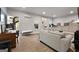 Bright living room with backyard access, comfortable couches, and a dedicated work space at 1412 Short Ct, Mcdonough, GA 30252