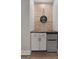 Stylish wet bar area with a mini-fridge, white cabinets, and modern hardware at 1412 Short Ct, Mcdonough, GA 30252