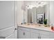 Bathroom with double vanity, cabinets, and view to stairs at 1690 Geranium Ln, Cumming, GA 30040