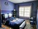 bedroom features cool blue color scheme and window letting in natural light at 1690 Geranium Ln, Cumming, GA 30040