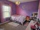bedroom with pink and purple decor and a chandelier at 1690 Geranium Ln, Cumming, GA 30040