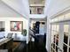 Bright foyer features soaring ceilings and dark hardwood floors with open staircase at 1690 Geranium Ln, Cumming, GA 30040