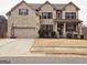 Charming two-story brick home with well-maintained landscaping and an attached two-car garage at 1690 Geranium Ln, Cumming, GA 30040