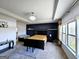 Spacious primary suite with a dark accent wall, tray ceiling, and sitting area at 1690 Geranium Ln, Cumming, GA 30040