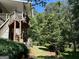 The spacious backyard includes a wooden deck and an expansive lawn at 245 River Laurel Way, Woodstock, GA 30188