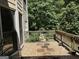 Back deck with gravel and stone pavers overlooking green trees at 245 River Laurel Way, Woodstock, GA 30188