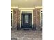 Elegant front door with sidelights flanked by lion statues on a classic brick home at 245 River Laurel Way, Woodstock, GA 30188