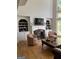 Living room with fireplace, built-in shelving and hardwood floors at 245 River Laurel Way, Woodstock, GA 30188