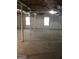 Unfinished basement featuring support beams, concrete floor, and natural light from windows at 436 Abbey Pl, Villa Rica, GA 30180