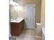 Well-lit bathroom with a single sink vanity, neutral color palette, and tiled floor at 436 Abbey Pl, Villa Rica, GA 30180