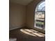 Bedroom featuring light brown walls, neutral carpet, and a large window with neighborhood view at 436 Abbey Pl, Villa Rica, GA 30180