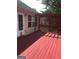 Red wooden deck area with lattice, and access to the home's interior at 436 Abbey Pl, Villa Rica, GA 30180