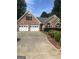 Charming brick home featuring a two-car garage and well-maintained landscaping at 436 Abbey Pl, Villa Rica, GA 30180