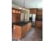 Spacious kitchen with an island, stainless steel fridge and ample cabinet space at 436 Abbey Pl, Villa Rica, GA 30180