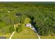 Stunning aerial view of estate home surrounded by lush greenery and mature trees at 692 Brooks Woolsey Rd, Brooks, GA 30205