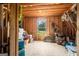 Attic storage space with plywood walls and floors, a window, and exposed beams at 692 Brooks Woolsey Rd, Brooks, GA 30205