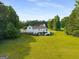 Expansive backyard featuring a large, well-maintained lawn and a two-story home at 692 Brooks Woolsey Rd, Brooks, GA 30205