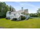 Large backyard with a sprawling lawn, a white house with a deck and patio at 692 Brooks Woolsey Rd, Brooks, GA 30205