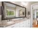 Elegant bathroom with a double sink vanity, a large mirror, and natural lighting at 692 Brooks Woolsey Rd, Brooks, GA 30205
