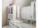 Bright bathroom with granite countertops, white cabinetry, and a glass-enclosed shower at 692 Brooks Woolsey Rd, Brooks, GA 30205