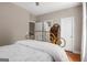Bedroom showcasing a brass bed frame, hardwood floors, and a charming secretary desk at 692 Brooks Woolsey Rd, Brooks, GA 30205