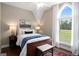 Serene bedroom with a large arched window, dark wood furniture and plush bedding at 692 Brooks Woolsey Rd, Brooks, GA 30205
