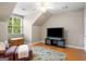 Cozy bedroom featuring a ceiling fan, window, and a wooden chest for storage at 692 Brooks Woolsey Rd, Brooks, GA 30205