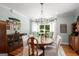 Traditional dining room with wood floors, chandelier, and large window with lots of natural light at 692 Brooks Woolsey Rd, Brooks, GA 30205