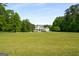 Two-story home with beautiful landscaping and a classic farmhouse design at 692 Brooks Woolsey Rd, Brooks, GA 30205