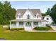 Charming two-story home with a welcoming porch and well-manicured lawn at 692 Brooks Woolsey Rd, Brooks, GA 30205