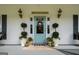 Charming front porch with a beautifully decorated entrance and potted plants at 692 Brooks Woolsey Rd, Brooks, GA 30205