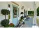 Welcoming front porch with a stylish door, planters, and cozy seating at 692 Brooks Woolsey Rd, Brooks, GA 30205