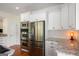 Bright kitchen featuring stainless steel appliances, white cabinets, and granite countertops at 692 Brooks Woolsey Rd, Brooks, GA 30205