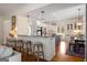Open kitchen and dining area with granite countertops, white cabinets, and pendant lighting at 692 Brooks Woolsey Rd, Brooks, GA 30205
