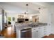 Stylish kitchen with granite counters, stainless dishwasher and cabinetry open to the living area at 692 Brooks Woolsey Rd, Brooks, GA 30205