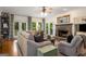 Inviting living room features a stone fireplace, plush sofa, and access to outdoor patio at 692 Brooks Woolsey Rd, Brooks, GA 30205
