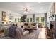 Bright living room featuring a fireplace, hardwood floors, and comfortable seating area at 692 Brooks Woolsey Rd, Brooks, GA 30205